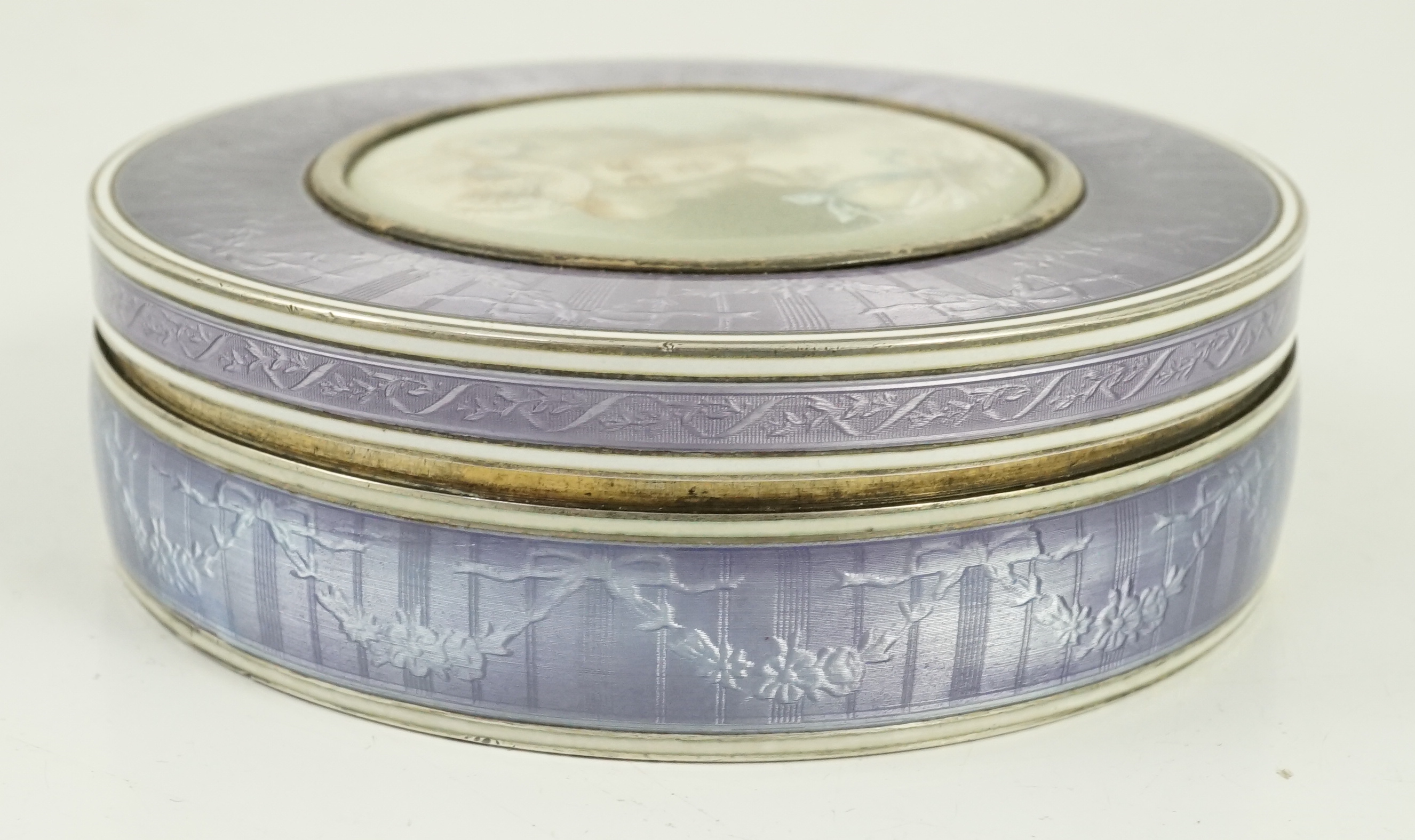 A 19th century French part engine turned silver and guilloche enamelled circular box and cover
